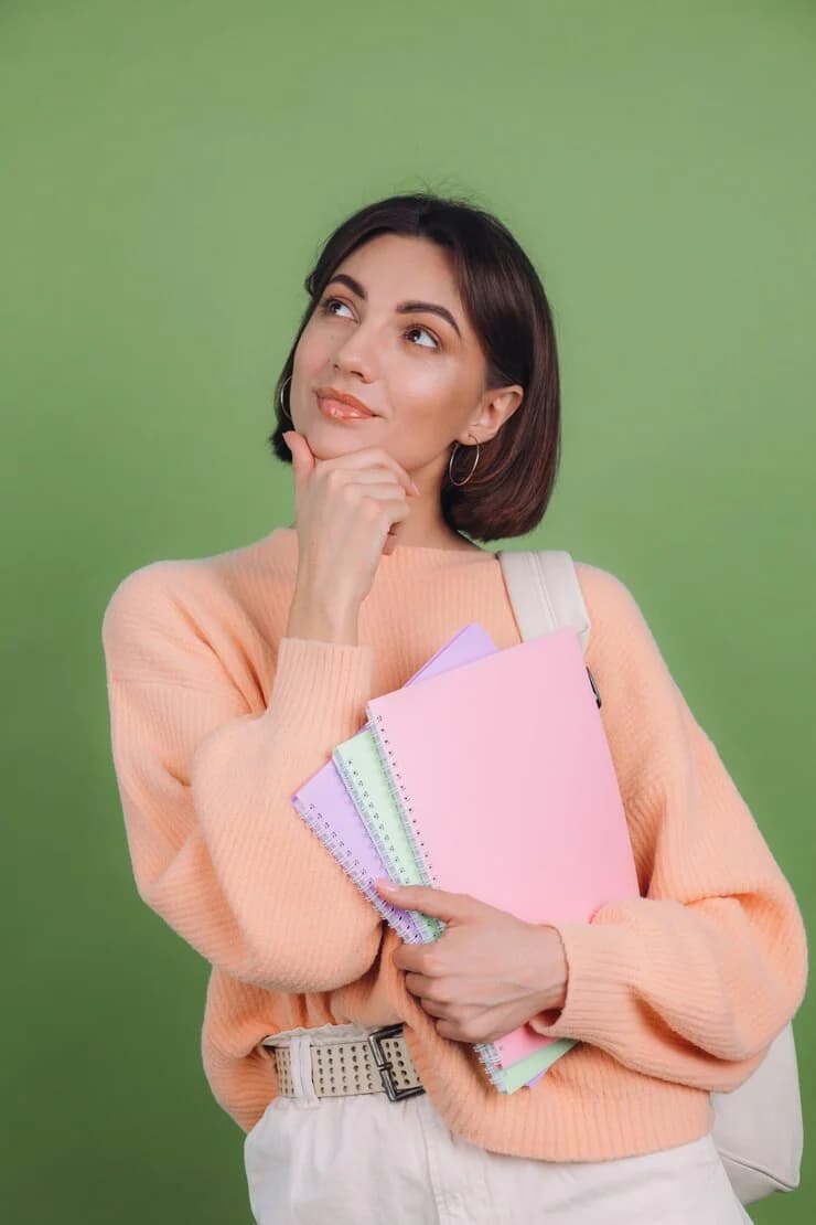 Instructor thinking while holding notebooks